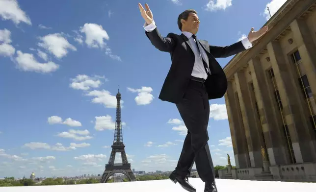 FILE - In this Tuesday May 1, 2012 file picture, French President and conservative candidate for his re-election in the 2012 French presidential elections, Nicolas Sarkozy reacts to supporters as he arrives on stage at Trocadero square. (AP Photo/Philippe Wojazer, Pool, File)