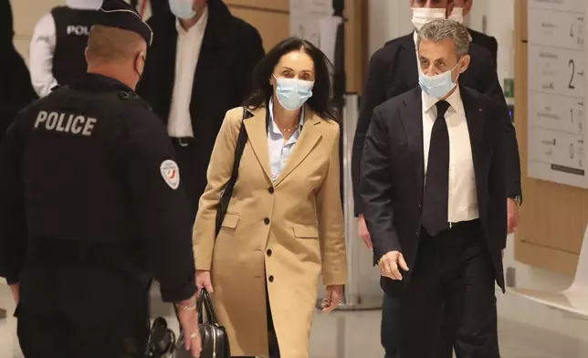 FILE - Former French President Nicolas Sarkozy, right, and his lawyer Jacqueline Laffont, center, arrive at the courtroom, Monday, Nov. 23, 2020 in Paris. (AP Photo/Michel Euler, File)