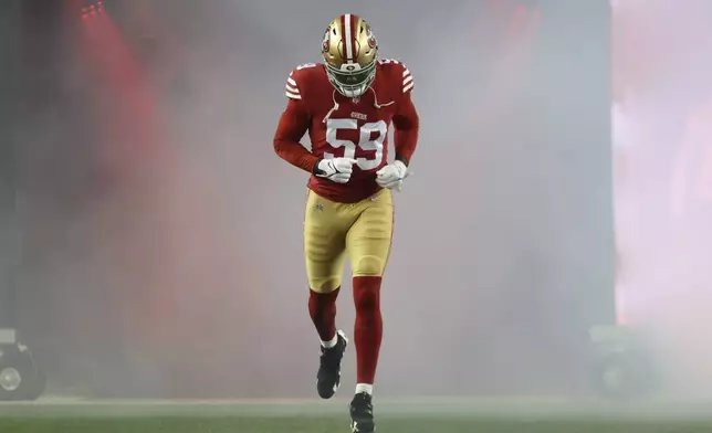 San Francisco 49ers linebacker De'Vondre Campbell jogs onto the field before an NFL football game against the Los Angeles Rams in Santa Clara, Calif., Thursday, Dec. 12, 2024. (AP Photo/Jed Jacobsohn)