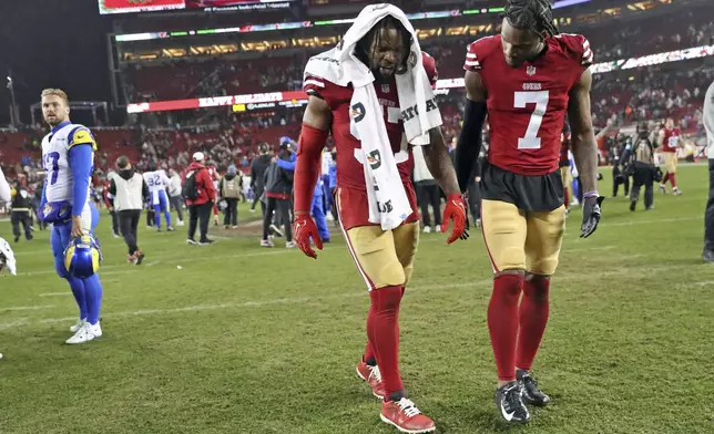 San Francisco 49ers' Dre Greenlaw, left, limps off the field with Charvarius Ward (7) after an NFL football game against the Los Angeles Rams at Levi's Stadium in Santa Clara, Calif., on Thursday, Dec. 12, 2024. (Scott Strazzante/San Francisco Chronicle via AP)