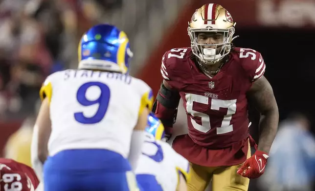 San Francisco 49ers linebacker Dre Greenlaw (57) watches as Los Angeles Rams quarterback Matthew Stafford (9) stands behind center during the second half of an NFL football game in Santa Clara, Calif., Thursday, Dec. 12, 2024. (AP Photo/Godofredo A. Vásquez)