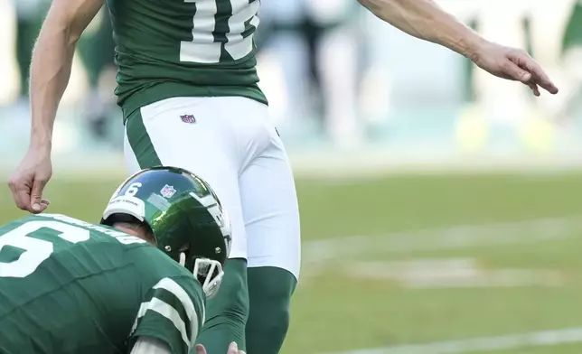New York Jets place kicker Anders Carlson (18) kicks a field goal during the first half of an NFL football game against the Miami Dolphins, Sunday, Dec. 8, 2024, in Miami Gardens, Fla. (AP Photo/Wilfredo Lee)
