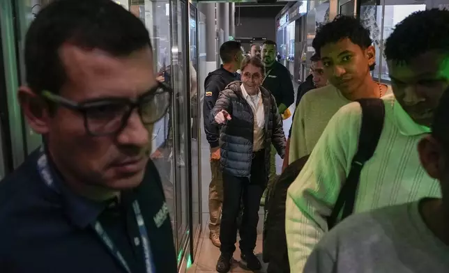 Fabio Ochoa, center, a former member of Cartel of Medellin, arrives at El Dorado airport after being deported from the U.S., in Bogota, Colombia, Monday, Dec. 23, 2024. (AP Photo/Fernando Vergara)