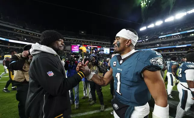 Philadelphia Eagles quarterback Jalen Hurts greets Pittsburgh Steelers head coach Mike Tomlin after an NFL football game Sunday, Dec. 15, 2024, in Philadelphia. (AP Photo/Derik Hamilton)