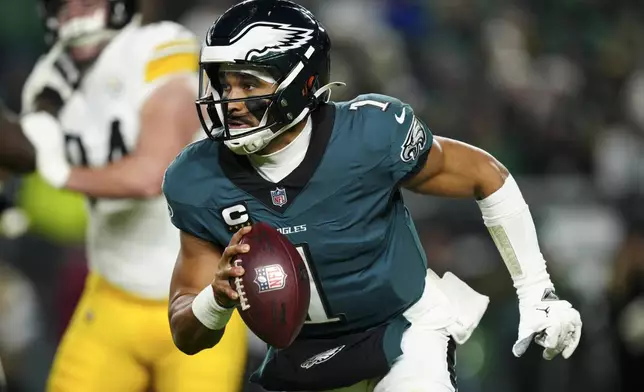 Philadelphia Eagles quarterback Jalen Hurts (1) runs the ball during the second half of an NFL football game against the Pittsburgh Steelers on Sunday, Dec. 15, 2024, in Philadelphia. (AP Photo/Derik Hamilton)