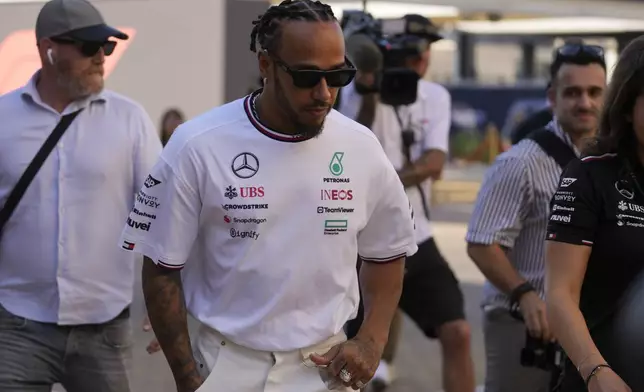 Mercedes driver Lewis Hamilton of Britain walks through paddock ahead of the Formula One Abu Dhabi Grand Prix, at the Yas Marina Circuit in Abu Dhabi, UAE, Thursday, Dec. 5, 2024. (AP Photo/Darko Bandic)
