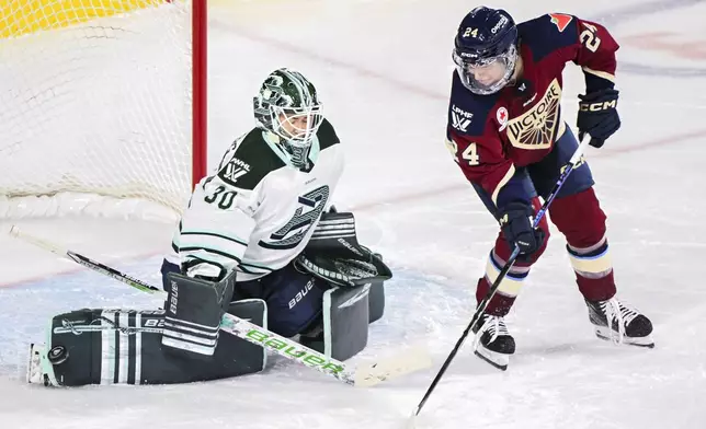 Boston Fleet goaltender Emma Soderberg, left, makes a save as Montreal Victoire's Abigail Boreen (24) moves in during first-period PWHL hockey game action in Laval, Quebec, Monday, Dec. 30, 2024. (Graham Hughes/The Canadian Press via AP)