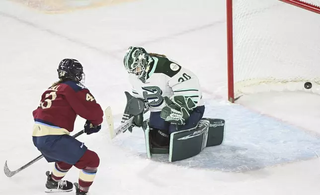 Montreal Victoire's Kristin O'Neill (43) scores against Boston Fleet goaltender Emma Soderberg (30) during second-period PWHL hockey game action in Laval, Quebec, Monday, Dec. 30, 2024. (Graham Hughes/The Canadian Press via AP)