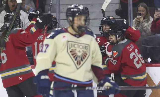 Ottawa Charge's Ashton Bell, second from right, celebrates after her goal with teammates during second-period PWHL hockey game action against the Montreal Victoire in Ottawa, Ontario, Friday, Dec. 6, 2024. (Patrick Doyle/The Canadian Press via AP)