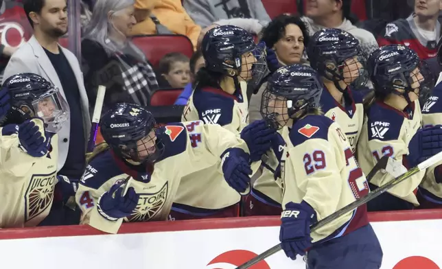 Montreal Victoire's Marie-Philip Poulin (29) celebrates after her goal with teammates during second-period PWHL hockey game action against the Ottawa Charge in Ottawa, Ontario, Friday, Dec. 6, 2024. (Patrick Doyle/The Canadian Press via AP)