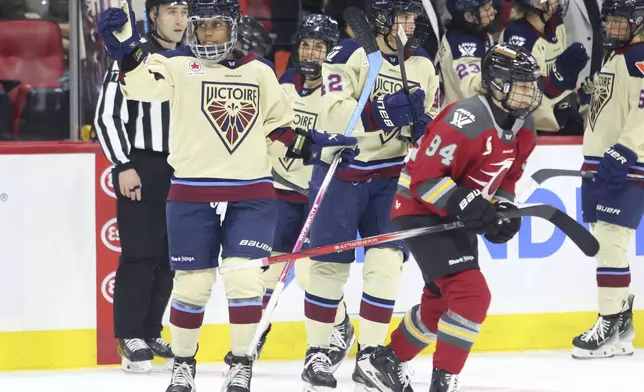 Montreal Victoire's Mikyla Grant-Mentis, front left, celebrates after her goal as Ottawa Charge's Anna Meixner (94) skates away during second-period PWHL hockey game action in Ottawa, Ontario, Friday, Dec. 6, 2024. (Patrick Doyle/The Canadian Press via AP)