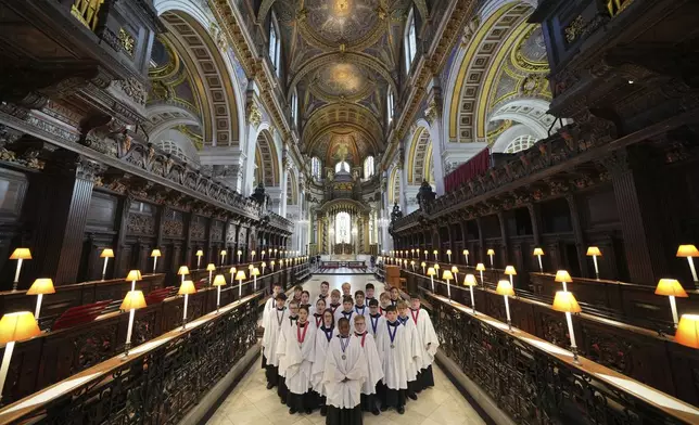 The Choristers of St Paul's choir, including girls for first time in 900-year history, rehearse for the Christmas services in St Paul's Cathedral, in London, Monday, Dec. 23 2024. (AP Photo/Kin Cheung)