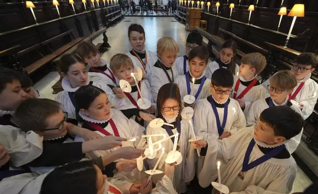 The Choristers of St Paul's choir, including girls for first time in 900-year history, rehearse for the Christmas services in St Paul's Cathedral, in London, Monday, Dec. 23 2024. (AP Photo/Kin Cheung)