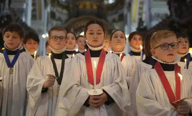 The Choristers of St Paul's choir, including girls for first time in 900-year history, rehearse for the Christmas services in St Paul's Cathedral, in London, Monday, Dec. 23 2024. (AP Photo/Kin Cheung)