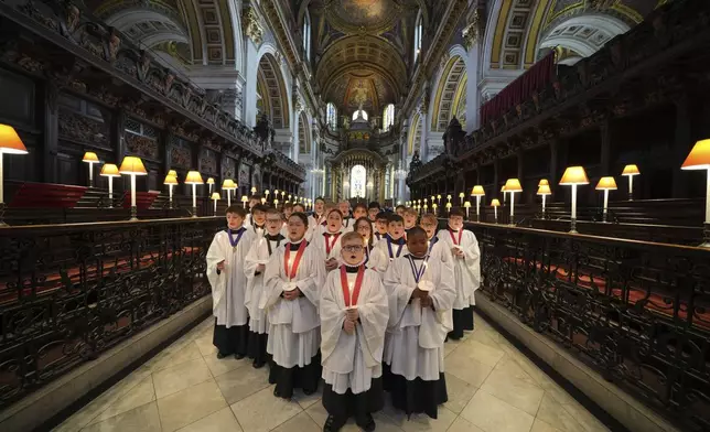 The Choristers of St Paul's choir, including girls for first time in 900-year history, rehearse for the Christmas services in St Paul's Cathedral, in London, Monday, Dec. 23 2024. (AP Photo/Kin Cheung)