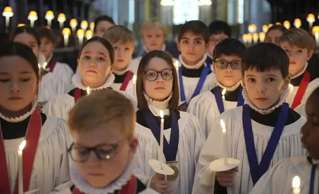 The Choristers of St Paul's choir, including girls for first time in 900-year history, rehearse for the Christmas services in St Paul's Cathedral, in London, Monday, Dec. 23 2024. (AP Photo/Kin Cheung)