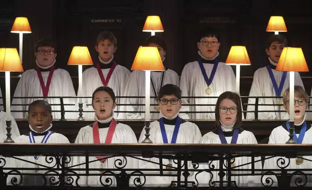 The Choristers of St Paul's choir, including girls for first time in 900-year history, rehearse for the Christmas services in St Paul's Cathedral, in London, Monday, Dec. 23 2024. (AP Photo/Kin Cheung)