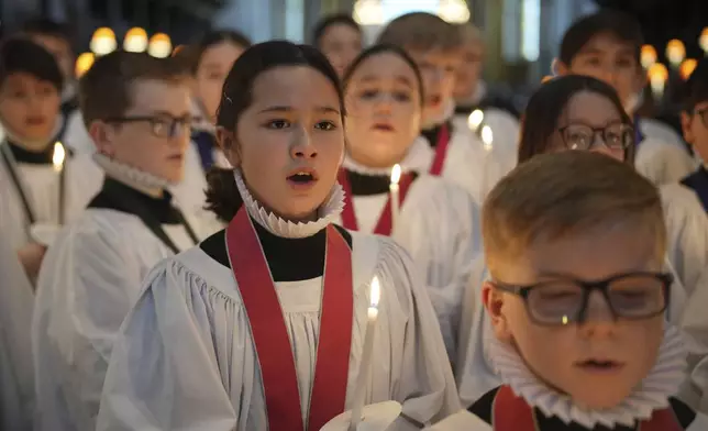 The Choristers of St Paul's choir, including girls for first time in 900-year history, rehearse for the Christmas services in St Paul's Cathedral, in London, Monday, Dec. 23 2024. (AP Photo/Kin Cheung)