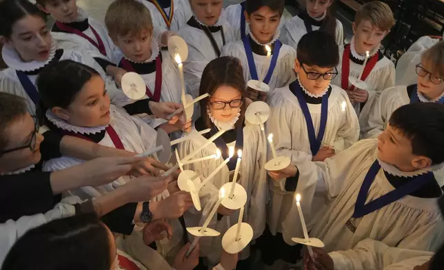 The Choristers of St Paul's choir, including girls for first time in 900-year history, rehearse for the Christmas services in St Paul's Cathedral, in London, Monday, Dec. 23 2024. (AP Photo/Kin Cheung)