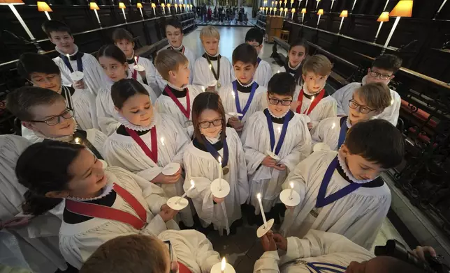 The Choristers of St Paul's choir, including girls for first time in 900-year history, rehearse for the Christmas services in St Paul's Cathedral, in London, Monday, Dec. 23 2024. (AP Photo/Kin Cheung)