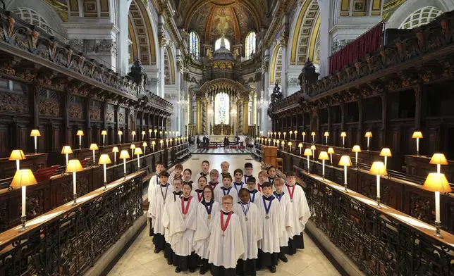 The Choristers of St Paul's choir, including girls for first time in 900-year history, rehearse for the Christmas services in St Paul's Cathedral, in London, Monday, Dec. 23 2024. (AP Photo/Kin Cheung)