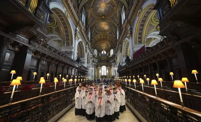 The Choristers of St Paul's choir, including girls for first time in 900-year history, rehearse for the Christmas services in St Paul's Cathedral, in London, Monday, Dec. 23 2024. (AP Photo/Kin Cheung)