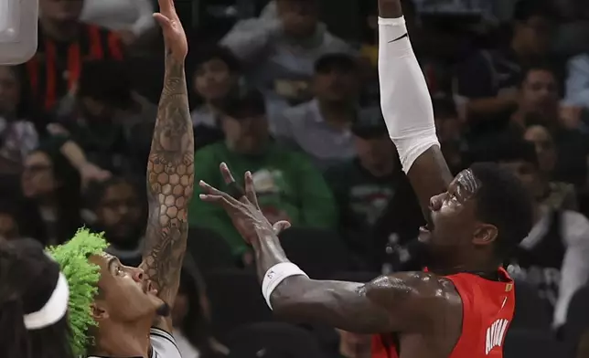 Portland Trail Blazers center Deandre Ayton (2) hoists a shot against San Antonio Spurs forward Jeremy Sochan (10) during the first half of an NBA basketball game in San Antonio, Saturday, Dec. 21, 2024. (AP Photo/Kin Man Hui)