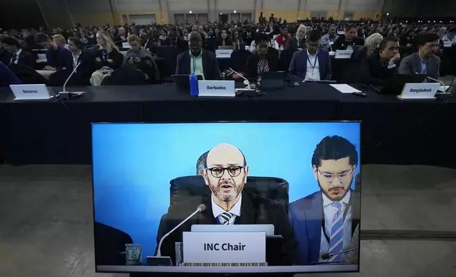 Chair of the International Negotiating Committee, Luis Vayas Valdivieso, on the screen, speaks during a plenary of the fifth session of the Intergovernmental Negotiating Committee on Plastic Pollution in Busan, South Korea, Sunday, Dec. 1, 2024. (AP Photo/Ahn Young-joon)