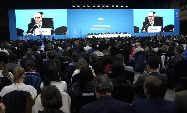 Chair of the International Negotiating Committee, Luis Vayas Valdivieso, on the screen, speaks during a plenary of the fifth session of the Intergovernmental Negotiating Committee on Plastic Pollution in Busan, South Korea, Sunday, Dec. 1, 2024. (AP Photo/Ahn Young-joon)