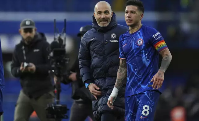 Chelsea's head coach Enzo Maresca, centre, and Chelsea's Enzo Fernandez celebrate after the English Premier League soccer match between Chelsea and Aston Villa at the Stamford Bridge stadium in London, Sunday, Dec. 1, 2024. (AP Photo/Kirsty Wigglesworth)