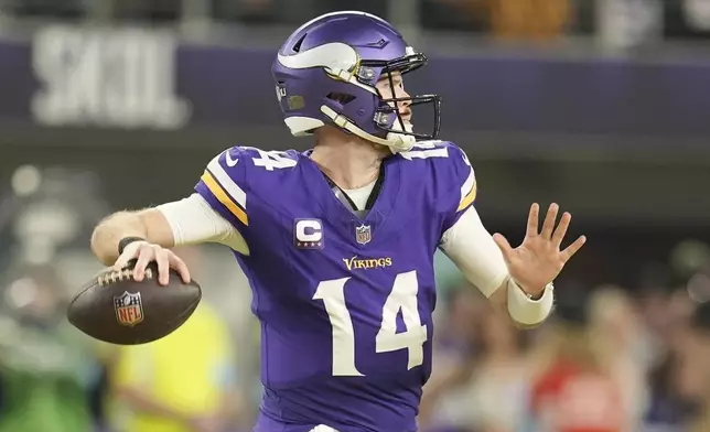 Minnesota Vikings' Sam Darnold throws during the second half of an NFL football game against the Green Bay Packers Sunday, Dec. 29, 2024, in Minneapolis. (AP Photo/Abbie Parr)