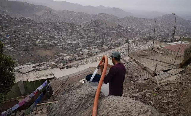 A resident fills his water tank at the Pamplona Alta hilltop neighborhood in Lima, Peru, March 8, 2024. (AP Photo/Martin Mejia)