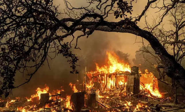 Flames consume a structure on Bessie Lane as the Thompson Fire burns in Oroville, Calif., July 2, 2024. (AP Photo/Noah Berger)