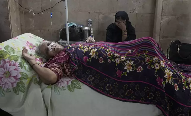 A patient suffering from heatstroke receives treatment at a hospital in Karachi, Pakistan, June 25, 2024. (AP Photo/Fareed Khan)