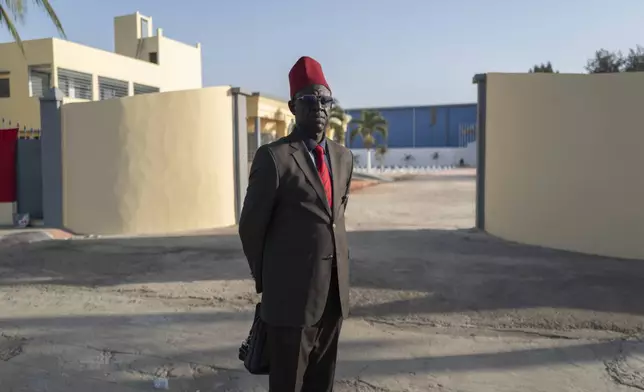 Thierno Birahim Gueye, president of the Federation of Associations of Descendants of Senegalese Tirailleurs in Africa, poses in front of the Thiaroye, Senegal, military cemetery Thursday, Nov. 28, 2024. (AP Photo/Sylvain Cherkaoui)