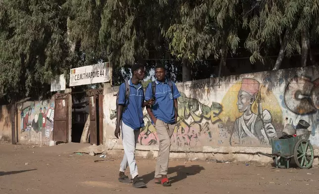 Students walk by the Thiaroye 44 college in Thiaroye, Senegal, Thursday, Nov. 28, 2024. (AP Photo/Sylvain Cherkaoui)