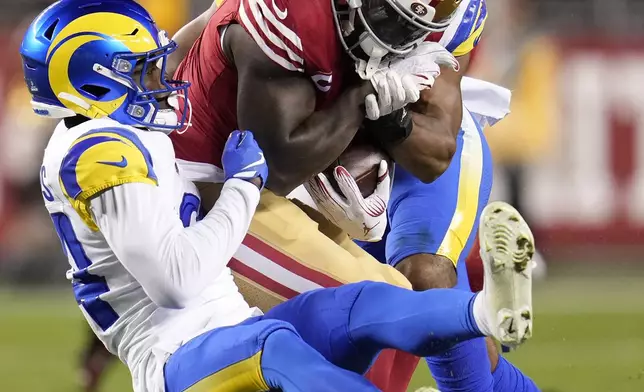 San Francisco 49ers wide receiver Deebo Samuel Sr. (1) runs against Los Angeles Rams cornerback Darious Williams, left, during the first half of an NFL football game in Santa Clara, Calif., Thursday, Dec. 12, 2024. (AP Photo/Godofredo A. Vásquez)