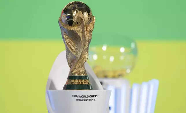 The World Cup trophy is seen before the UEFA Preliminary Draw for the 2026 FIFA World Cup at FIFA headquarters in Zurich, Switzerland, Friday, December 13, 2024. (Til Buergy/Keystone via AP)