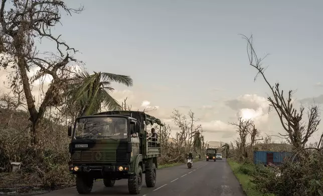 French military vehicles make their way to the central city of Mirereni, Mayotte, Friday, Dec. 20, 2024. (AP Photo/Adrienne Surprenant)