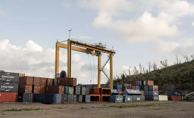 Fallen containers litter the Longoni port, Mayotte, Friday, Dec. 20, 2024. (AP Photo/Adrienne Surprenant)