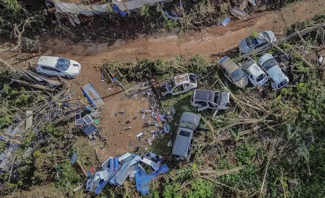 Drone view of destroyed cars in Mirereni, Mayotte, Friday, Dec. 20, 2024. (AP Photo/Adrienne Surprenant)