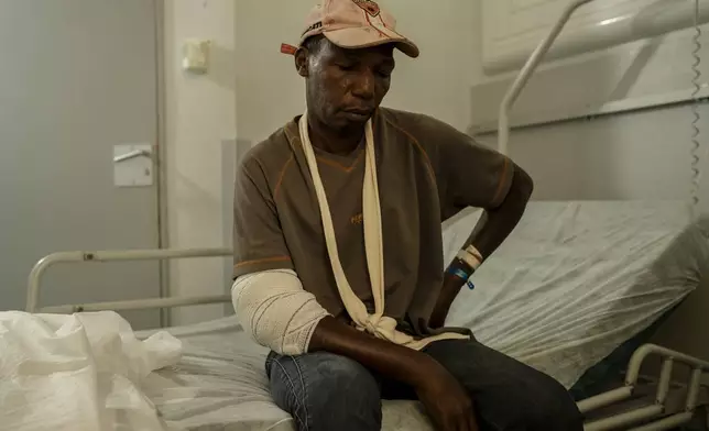 Saindou Mohamadi, father of 6, sits on his bed at the Mayotte Central Hospital after being injured while attempting to reach his home in Mamoudzou, Mayotte, Tuesday, Dec. 20, 2024. (AP Photo/Adrienne Surprenant)