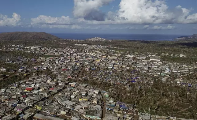 Drone view of destroyed dwellings in Mirereni, Mayotte, Friday, Dec. 20, 2024. (AP Photo/Adrienne Surprenant)