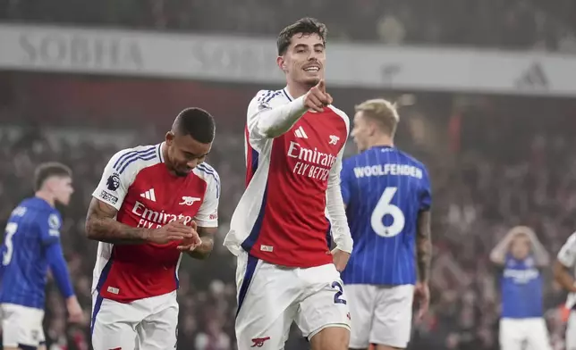 Arsenal's Kai Havertz, center, celebrates after scoring the opening goal during the English Premier League soccer match between Arsenal and Ipswich at the Emirates Stadium in London, England, Friday, Dec. 27, 2024. (John Walton/PA via AP)