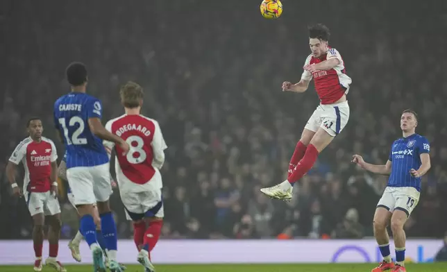 Arsenal's Declan Rice leaps high to head the ball during the English Premier League soccer match between Arsenal and Ipswich at the Emirates Stadium in London, Friday, Dec. 27, 2024. (AP Photo/Kin Cheung)