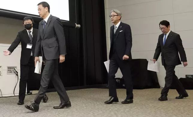 Nissan Chief Executive Makoto Uchida, left, and Honda Chief Executive Toshihiro Mibe, center, and Takao Kato CEO of Mitsubishi Motors, right, arrive to attend a joint news conference Monday, Dec. 23, 2024, in Tokyo, Japan. (AP Photo/Eugene Hoshiko)