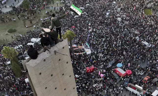 Syrians continue to celebrate the ousting of Bashar al-Assad's government, at Umayyad Square, in Damascus, Syria, Friday, Dec. 20, 2024. (AP Photo/Hussein Malla)