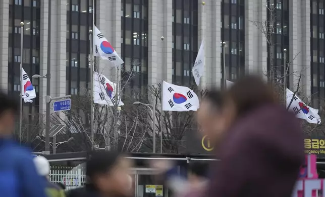 South Korean national flags fly at half-mast at the government complex, in Seoul, South Korea, Monday, Dec. 30, 2024. (AP Photo/Lee Jin-man)