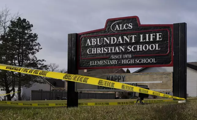 Police tape is seen outside the Abundant Life Christian School Tuesday, Dec. 17, 2024 in Madison, Wis., following a shooting on Monday. (AP Photo/Morry Gash)