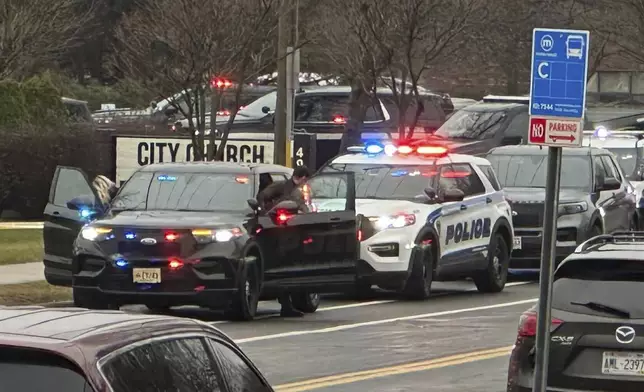 Emergency vehicles are parked outside the Abundant Life Christian School in Madison, Wis., where multiple injuries were reported following a shooting, Monday, Dec. 16, 2024. (AP Photo/Scott Bauer)